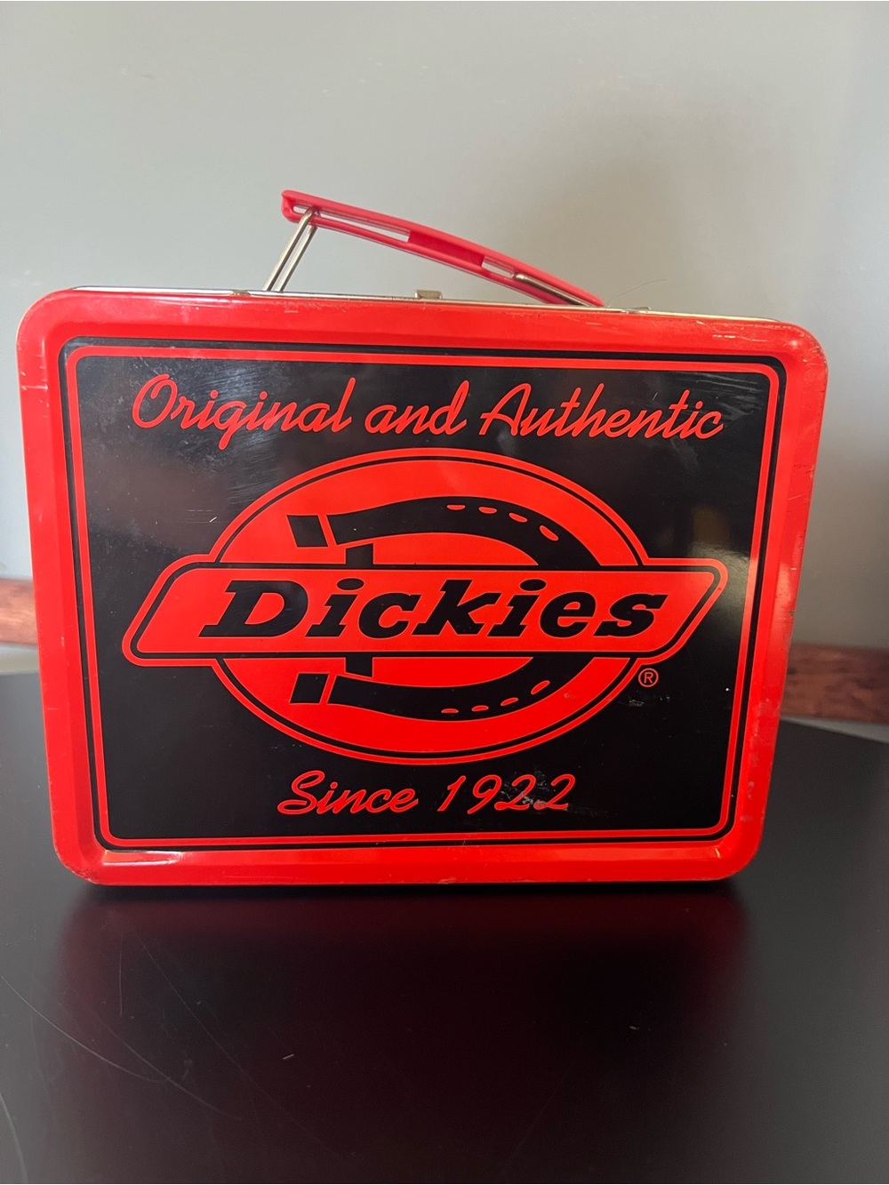 Collectible red metal Dickies brand lunch box